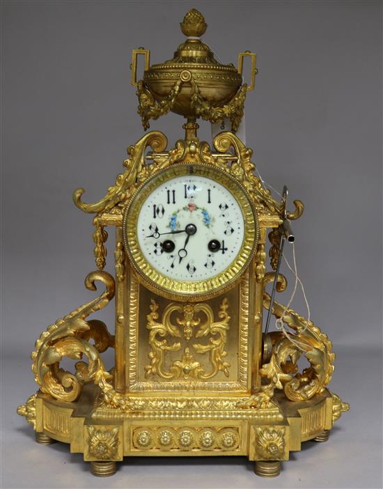 A 19th century French gilt bronze eight day mantel clock, with floral painted dial, with key and pendulum, height 40cm